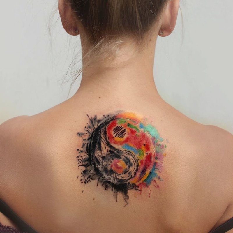 Colorful yin-yang tattoo on back for women