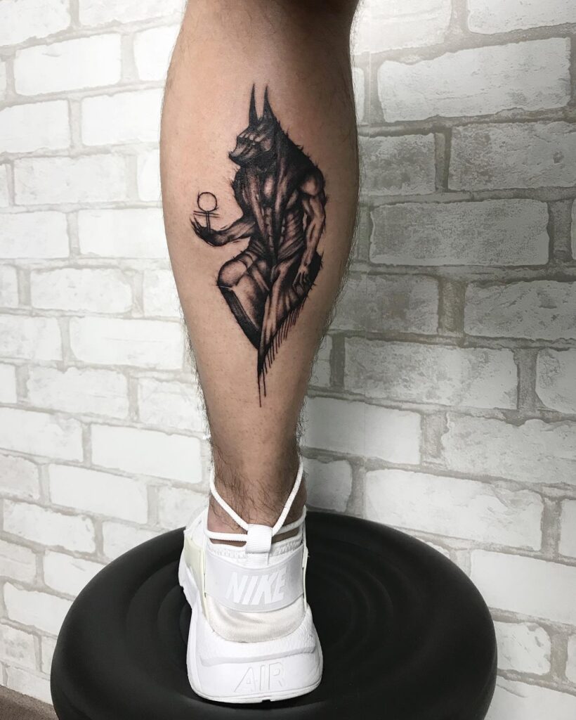 Anubis tattoo on the calf for men