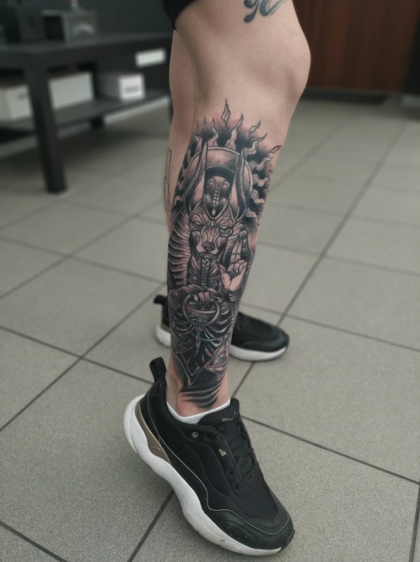 Anubis tattoo on the shin for men