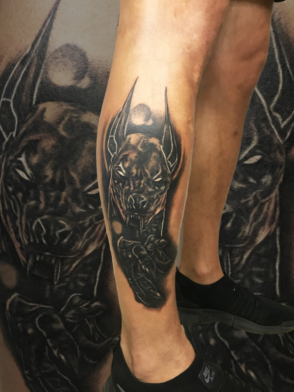 Anubis tattoo on the shin for men