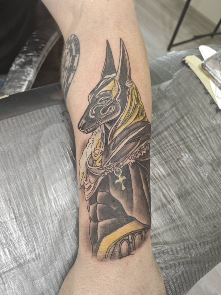 Anubis tattoo on the arm for men