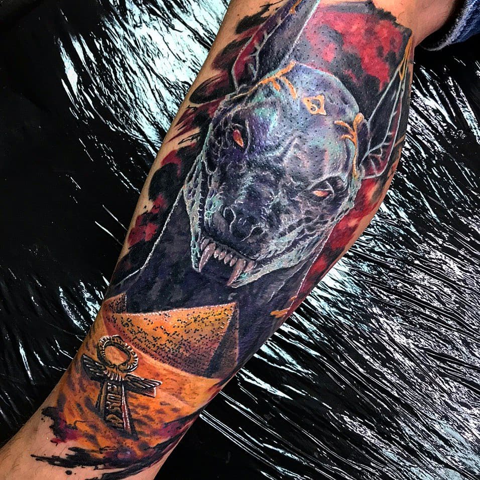 Anubis color tattoo on the arm for men