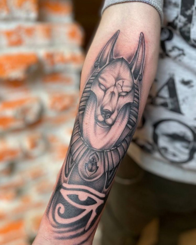 Anubis tattoo on the arm for men