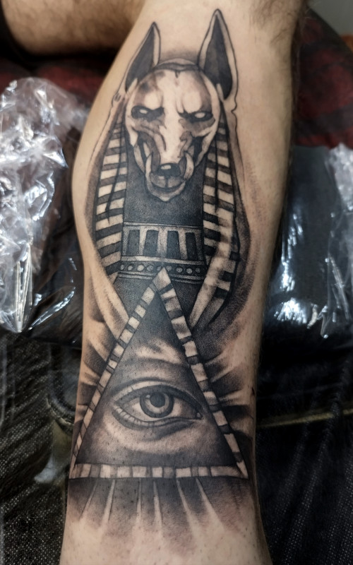 Anubis tattoo on the shin for men