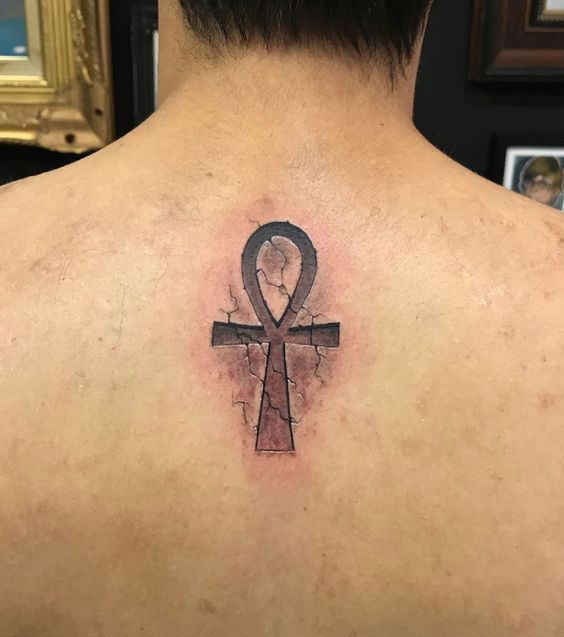 Ankh tattoo on the back for men