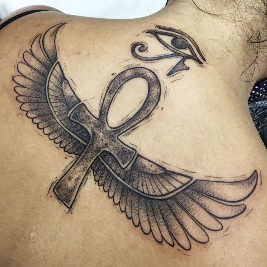 Ankh tattoo on the back for women