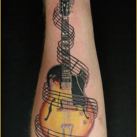 Guitar tattoo on forearm for men