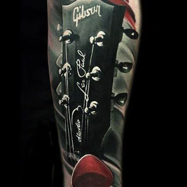 Guitar tattoo on the arm for men