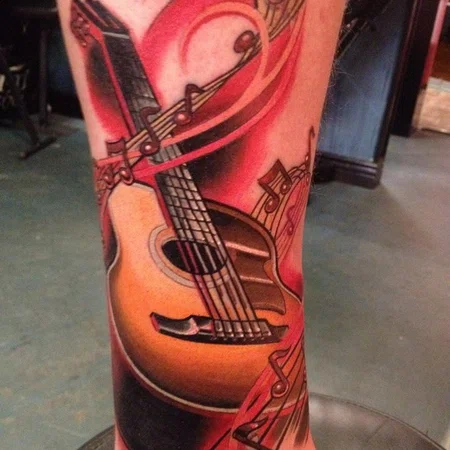 Colorful guitar tattoo on leg for men