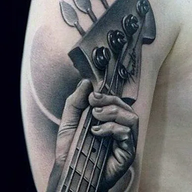 Guitar tattoo on the shoulder for men