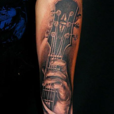 Guitar tattoo on forearm for men