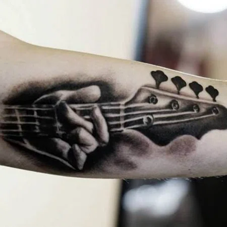 Guitar tattoo on the arm for men