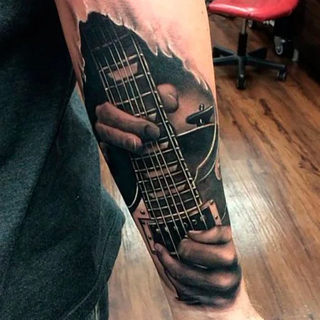 Guitar tattoo on the arm for men