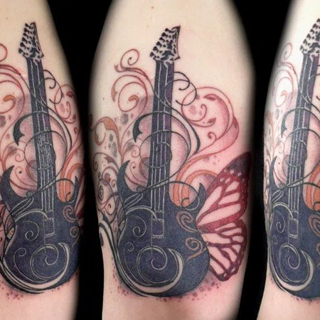 Guitar tattoo on the shoulder for men