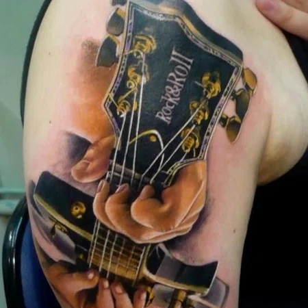 Large guitar tattoo on the shoulder for men