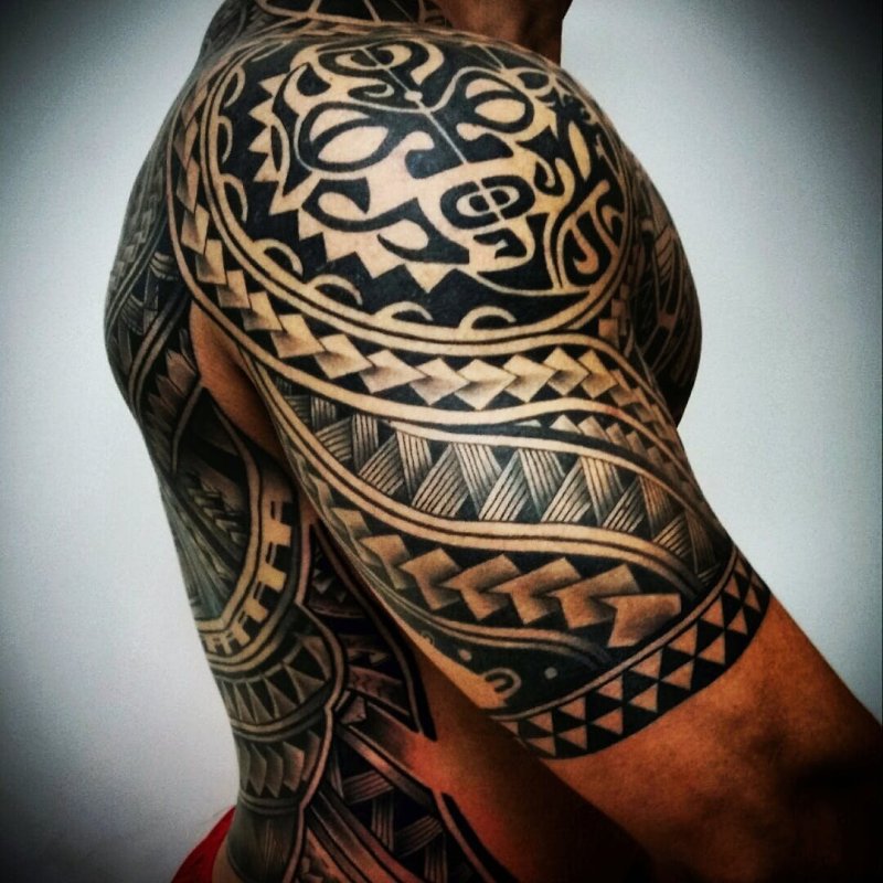 Polynesian style tattoo on the shoulder for men