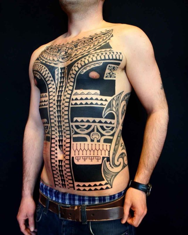 Polynesian style tattoo on the stomach for men