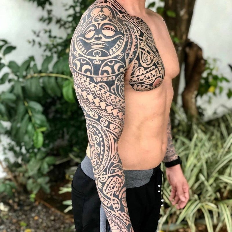 Polynesian style tattoo on the arm for men