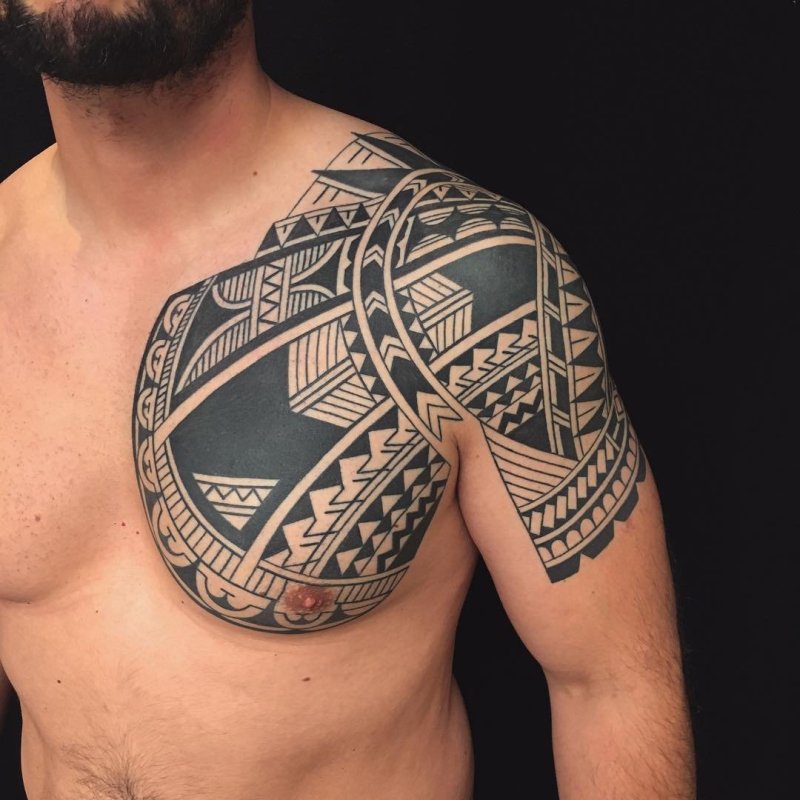 Polynesian style tattoo on the chest for men