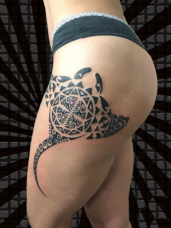 Polynesian style tattoo on the hip for women