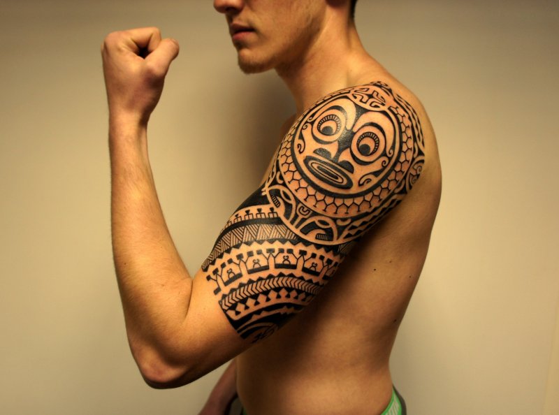 Polynesian style tattoo on the shoulder for men