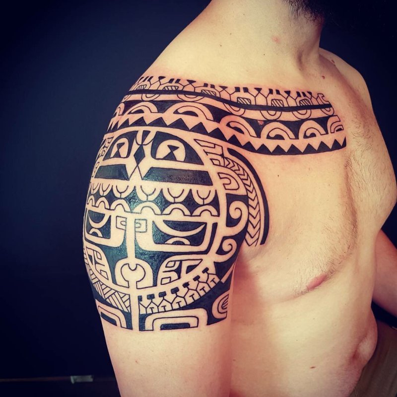 Polynesian style tattoo on the shoulder for men