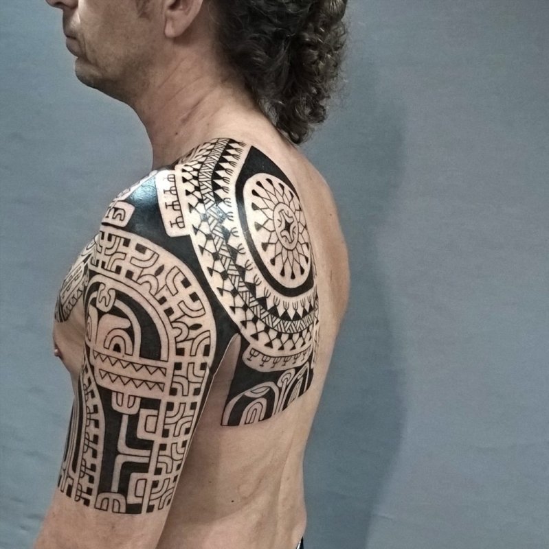 Polynesian style tattoo on the shoulder for men