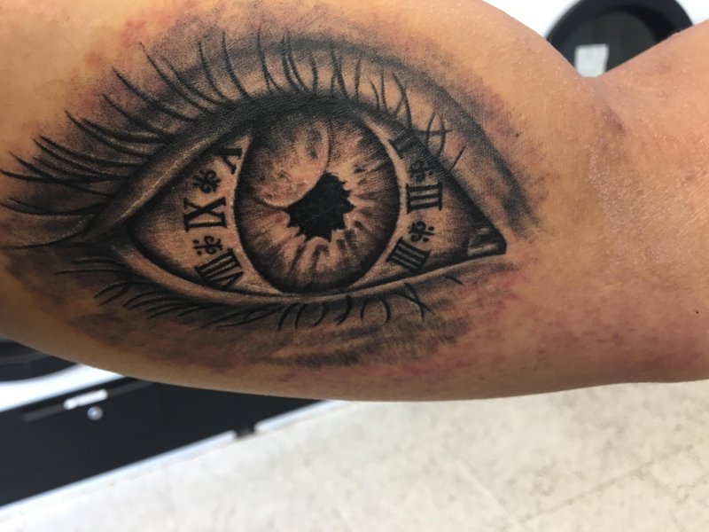 Eye tattoo on bicep for men