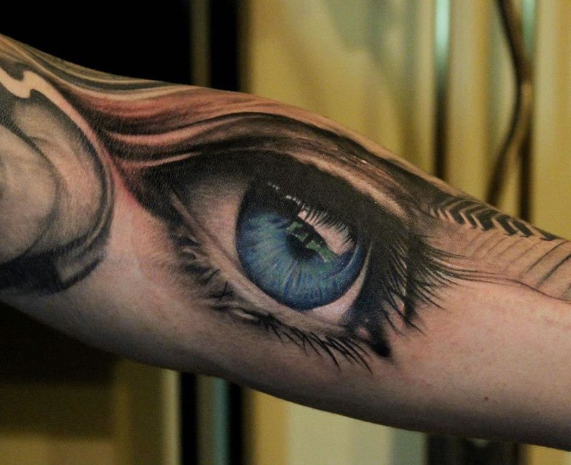 Colorful eye tattoo on arm for men