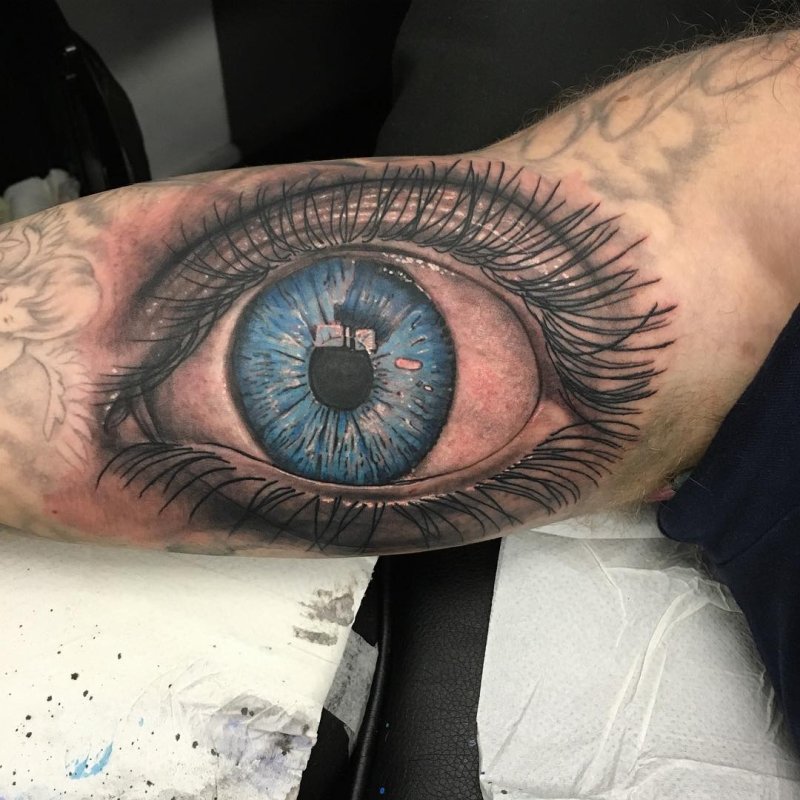 Eye tattoo on bicep for men