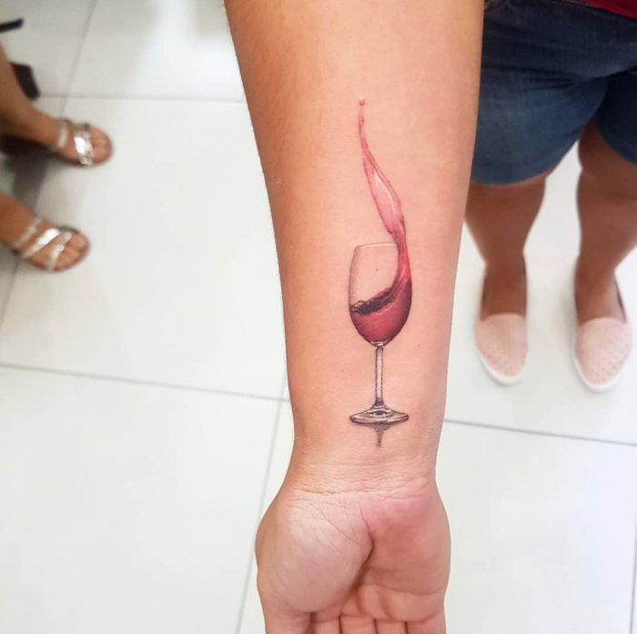 Wine tattoo on forearm for women