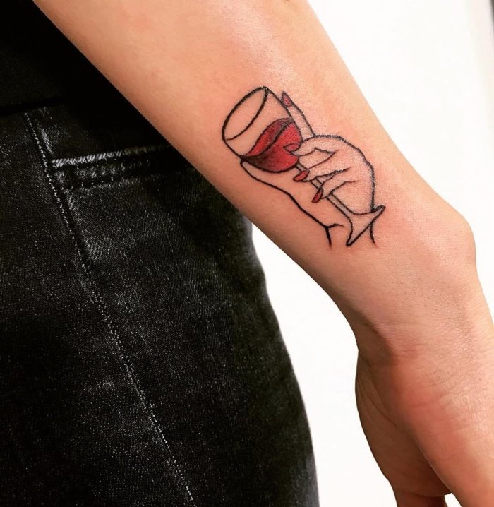 Wine tattoo on the arm for women