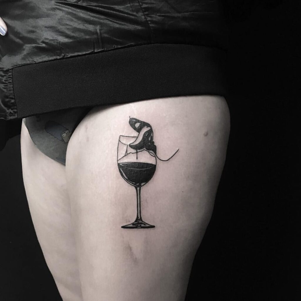 Wine tattoo on thigh for women