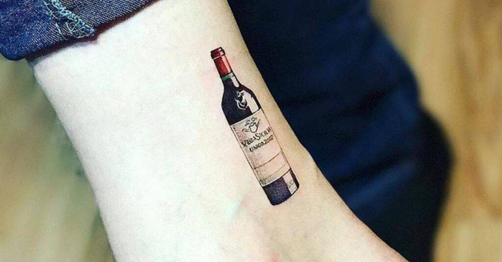 Large wine tattoo on ankle for men