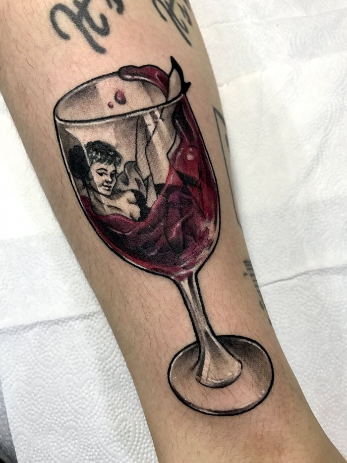 Wine and girl tattoo on the arm for men