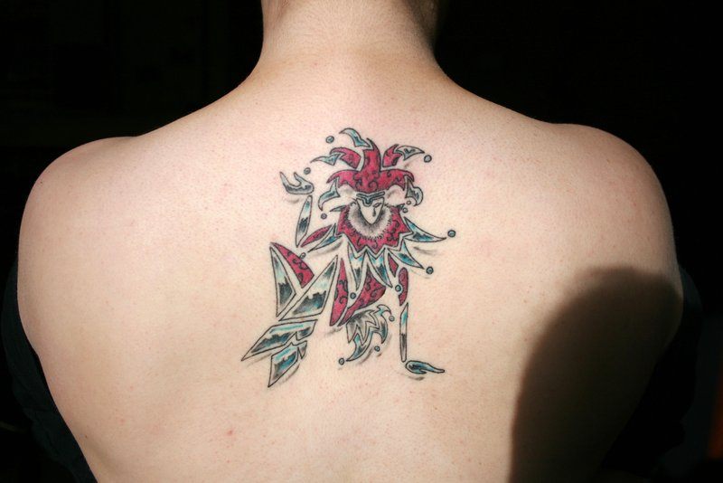 Harlequin tattoo on back for men