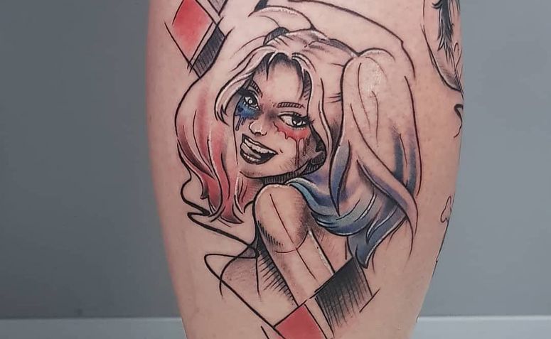 Harlequin tattoo on leg for women