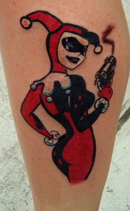 Harlequin tattoo on leg for women