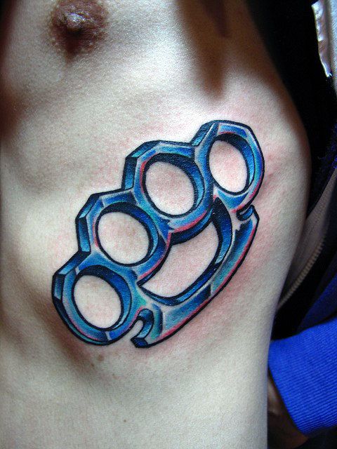 Colorful knuckle tattoo on the side for men