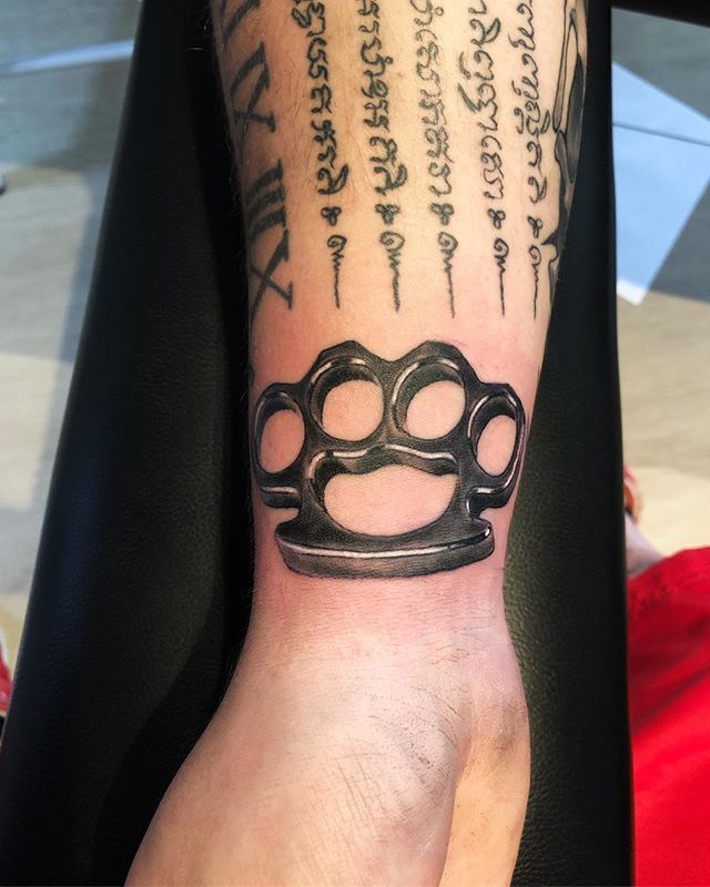 Knuckles tattoo on the wrist for men