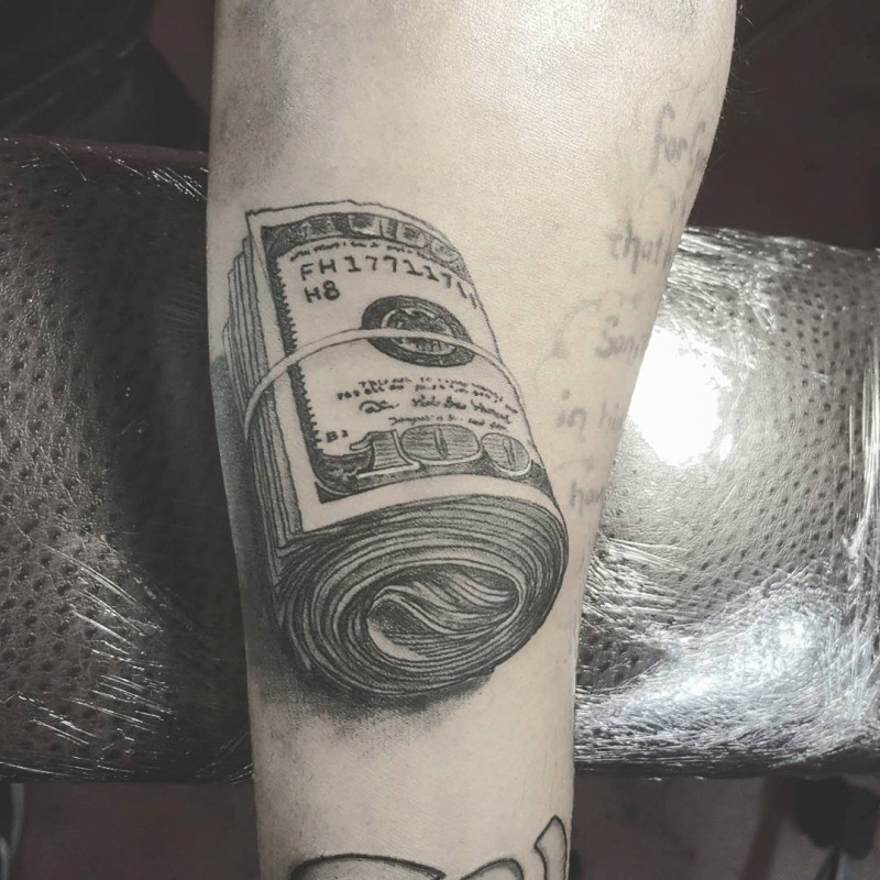 Money tattoo on arm for men