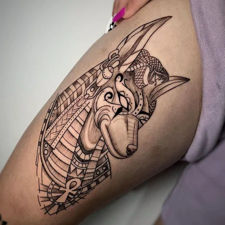 Anubis tattoo on the thigh for women