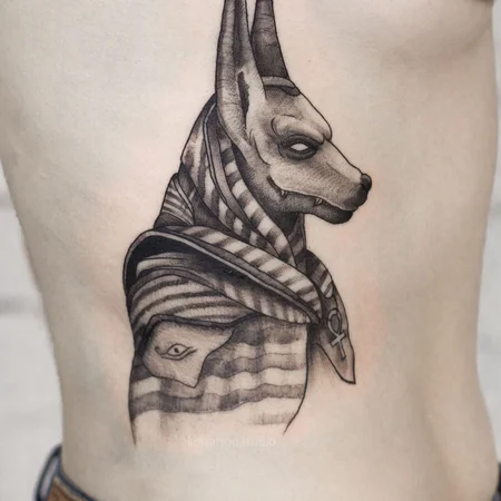 Anubis tattoo on the side for men