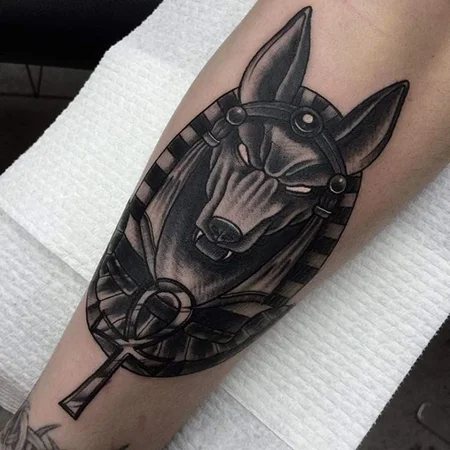 Anubis tattoo on the leg for men