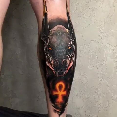 Anubis color tattoo on the calf for men