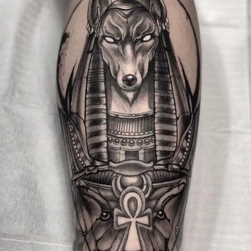 Anubis tattoo on the leg for men