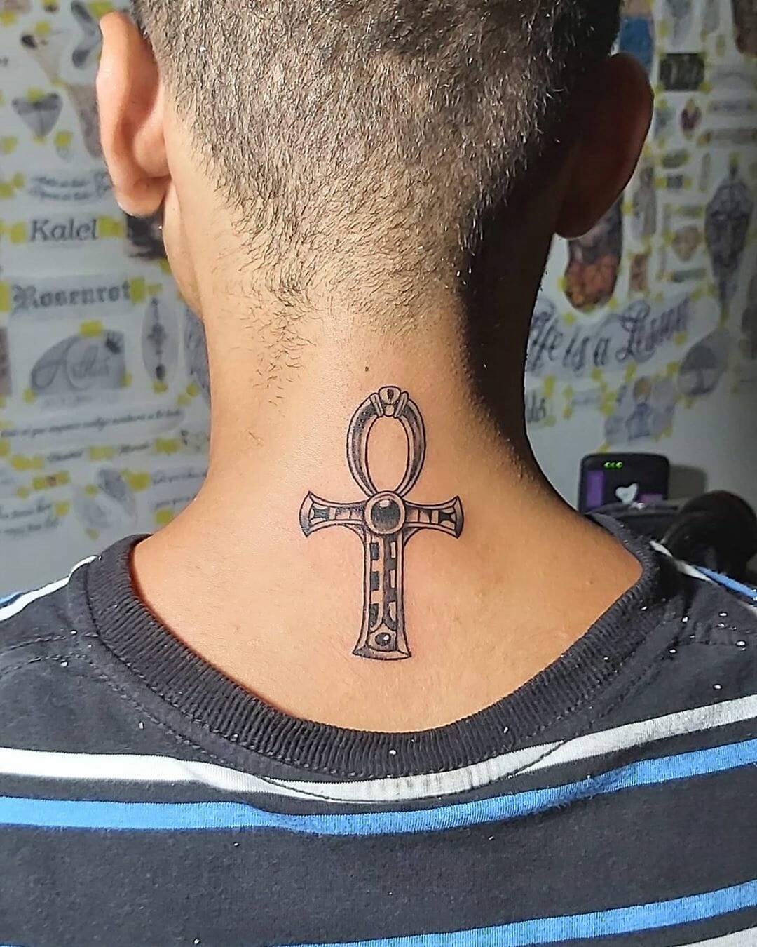 Ankh tattoo on the back of the head for men