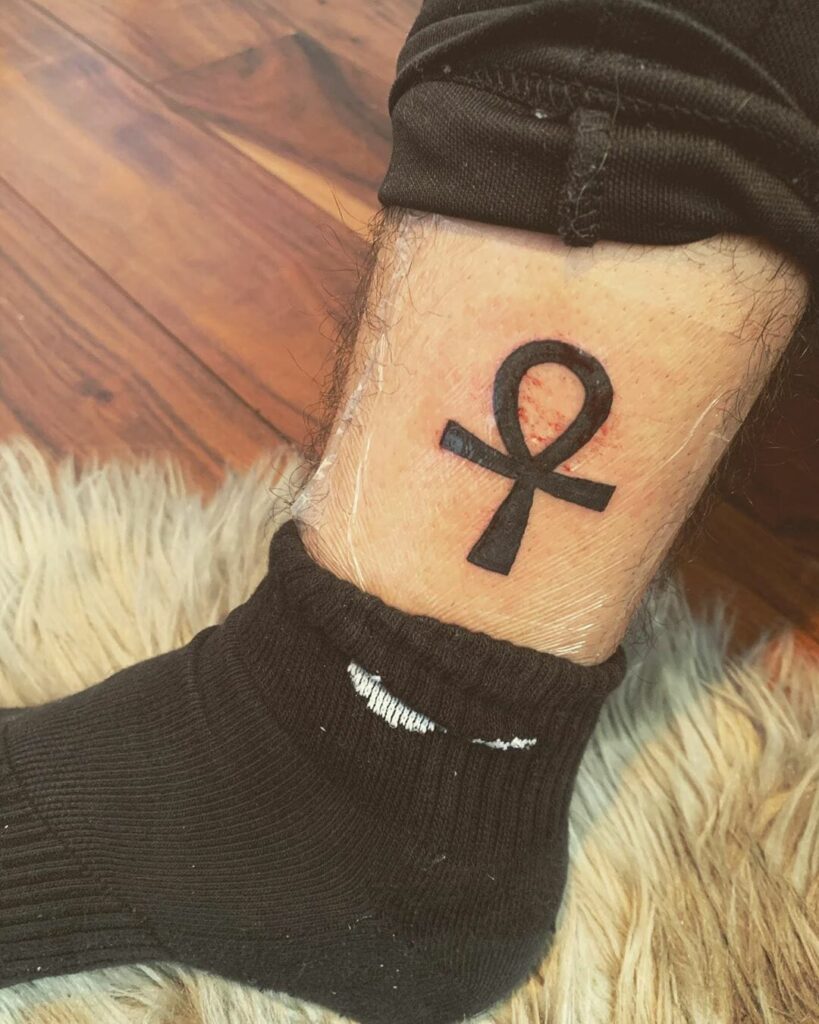 Ankh tattoo on the leg for men