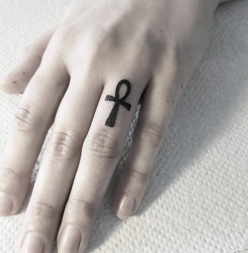 Ankh tattoo on the finger for women