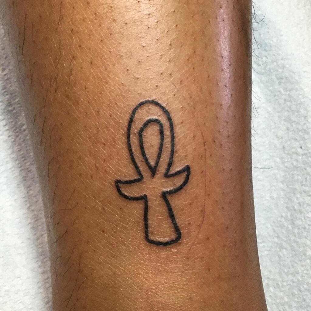 Ankh tattoo on the leg for women